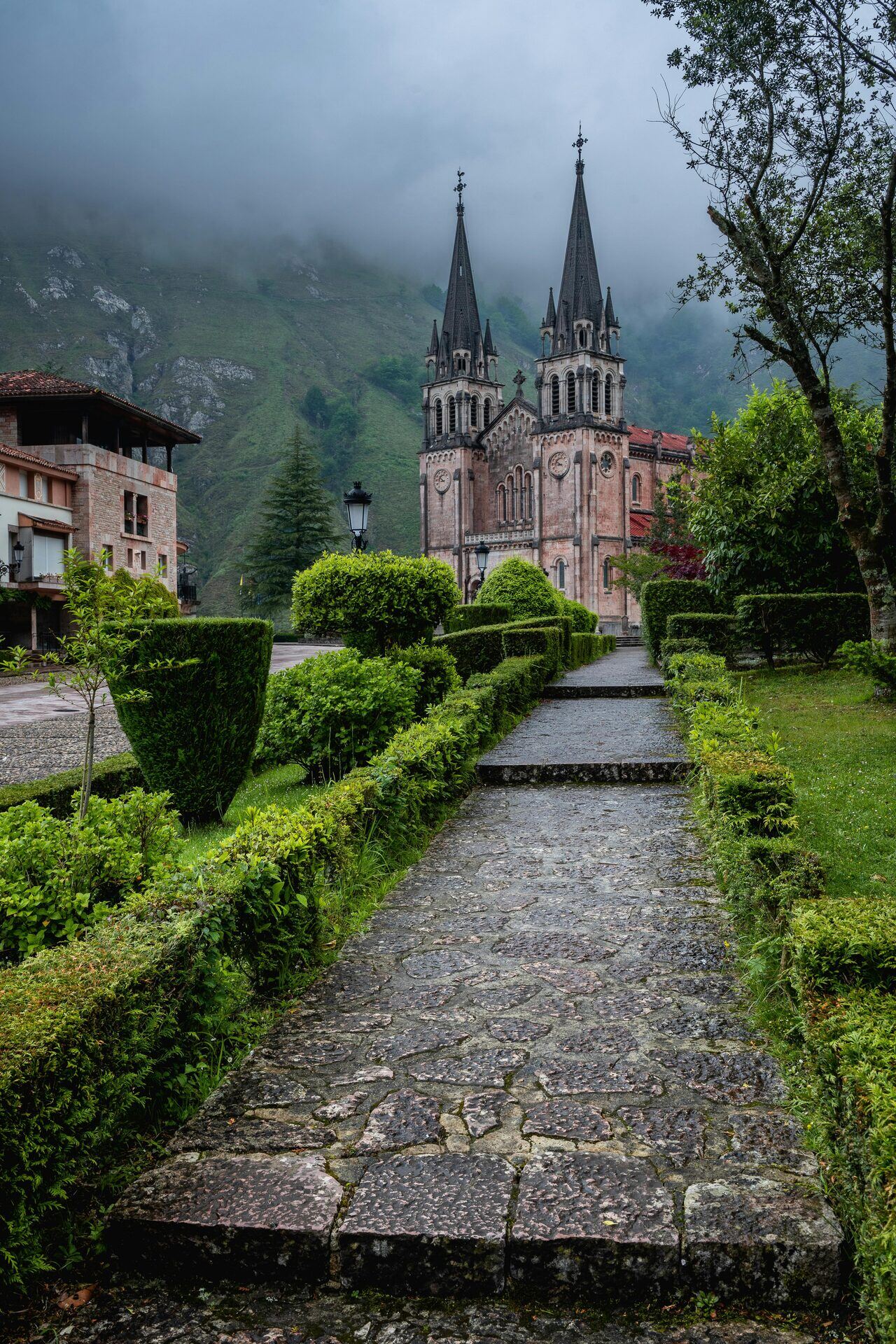 Sanctuary Of Covadonga With The Misty Picos De Europa Mountains
